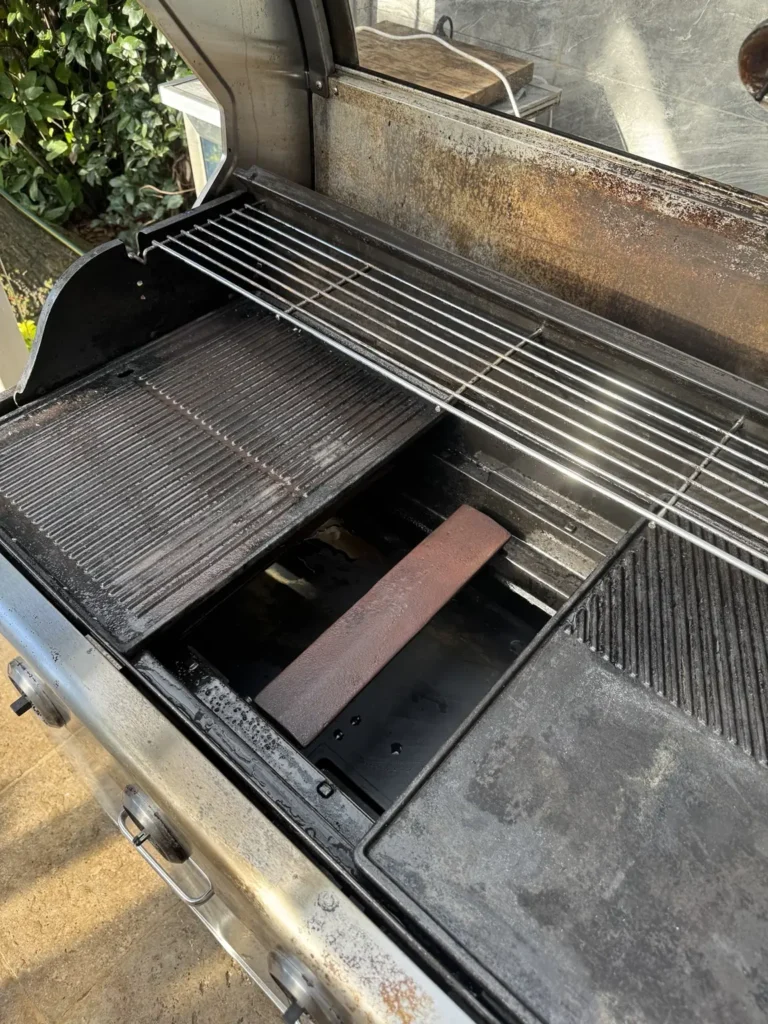 Detailed view of cleaned BBQ interior plates and warming rack