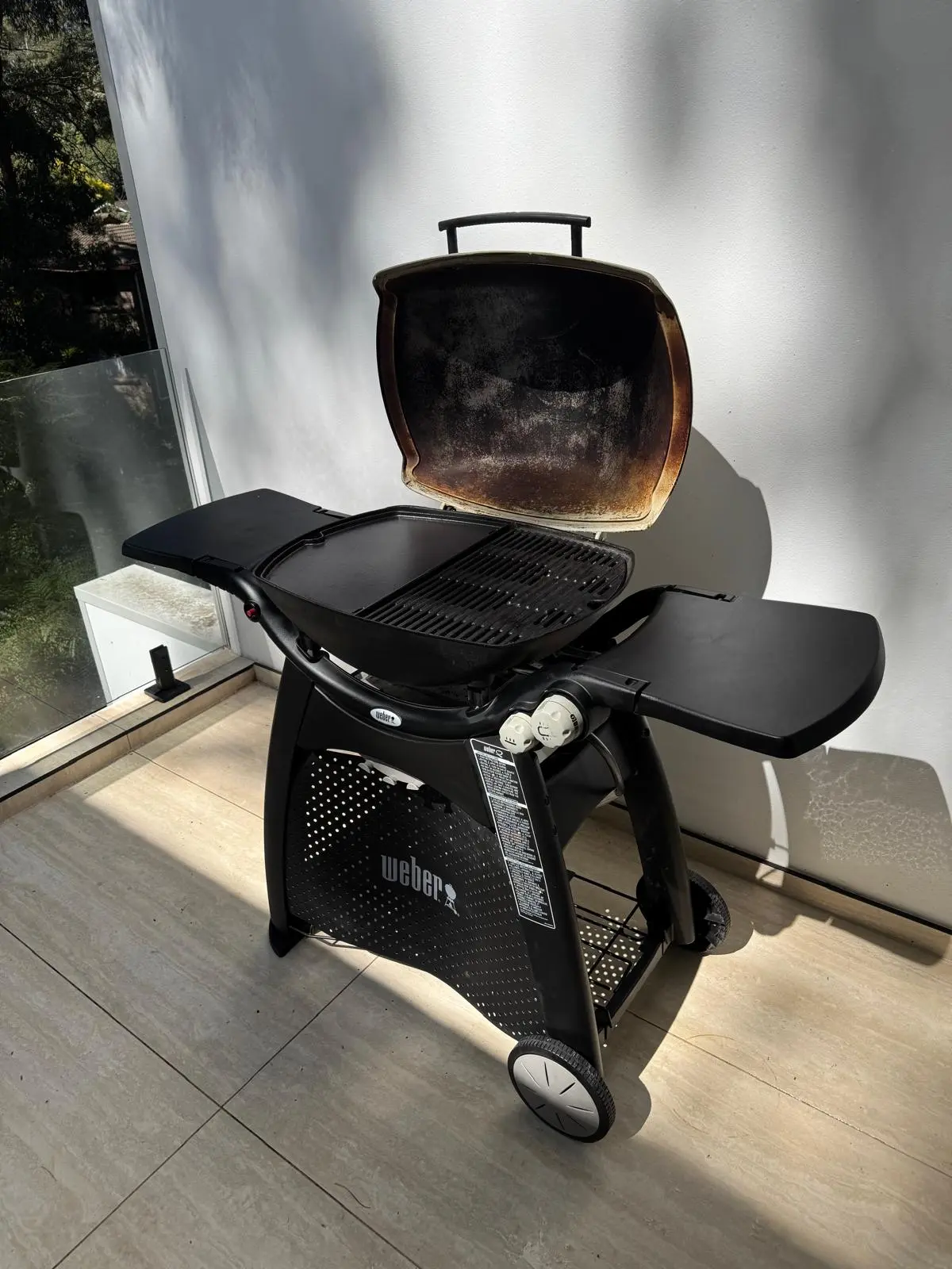 Complete Weber Q trolley BBQ open after detailed cleaning in Ryde