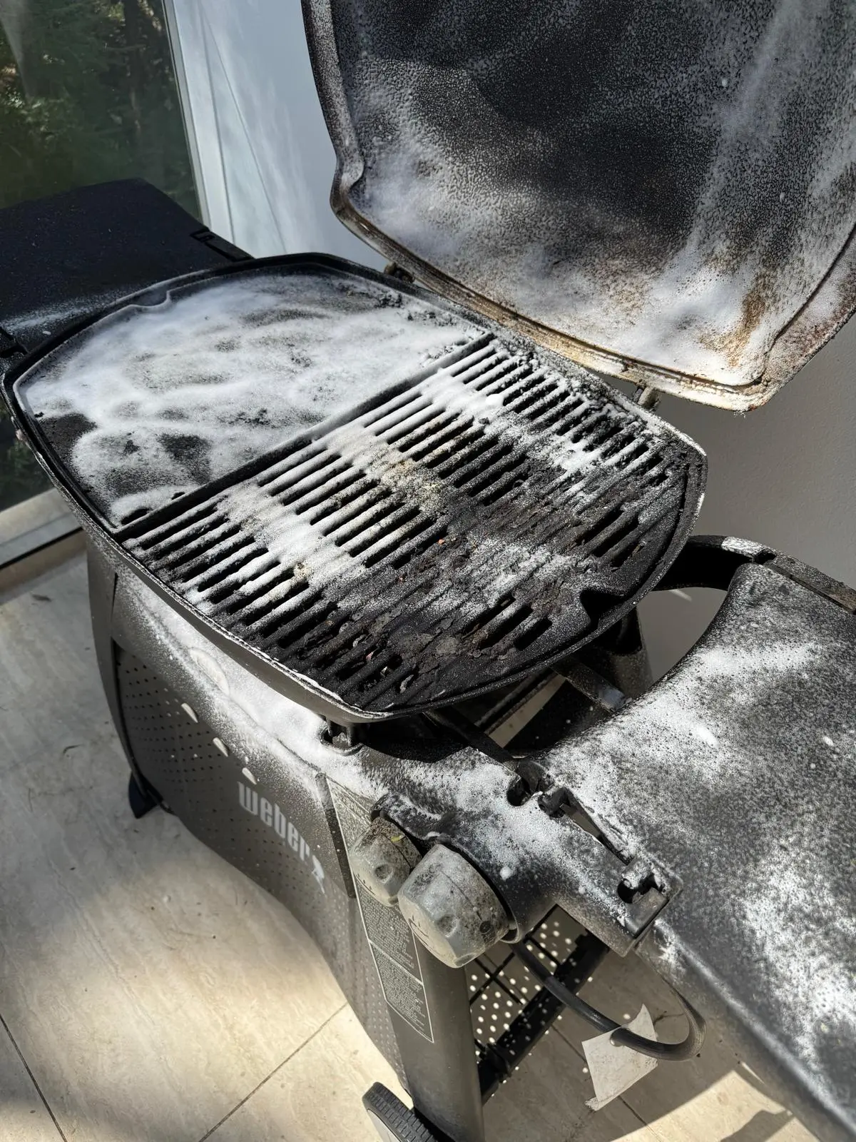 Weber Q BBQ cooking area in Ryde showing grease and carbon build-up before detailed cleaning