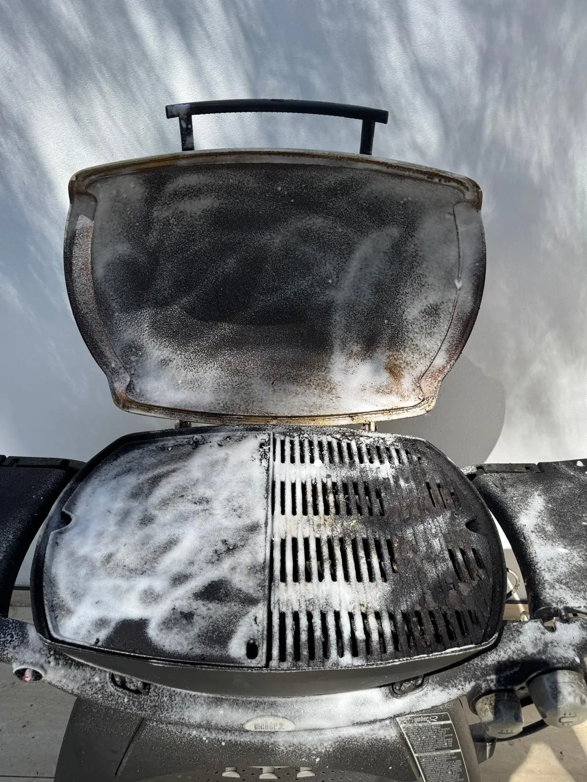 Weber Q BBQ cooking surfaces and hood in Ryde at the start of cleaning